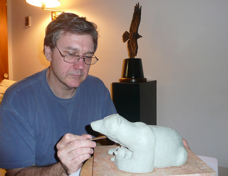 Shawn Working with Bear Sculpture